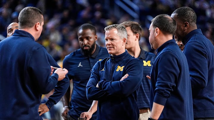 Michigan head coach Dusty May, center, talks to assistant coaches in a huddle at timeout against Villanova during the second half at Crisler Center in Ann Arbor on Tuesday, Dec. 9, 2025. Michigan head coach Dusty May, center, talks to assistant coaches in a huddle at timeout against Villanova during the second half at Crisler Center in Ann Arbor on Tuesday, Dec. 9, 2025.