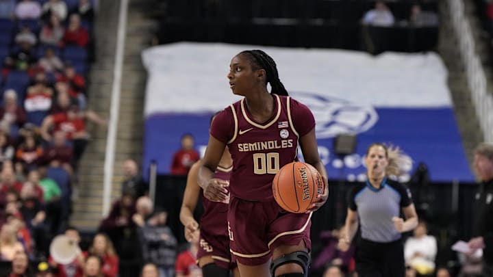 Mar 9, 2024; Greensboro, NC, USA; Florida State Seminoles guard Ta'Niya Latson (00) brings the ball up court against the NC State Wolfpack during the second half at Greensboro Coliseum. Mandatory Credit: David Yeazell-Imagn Images