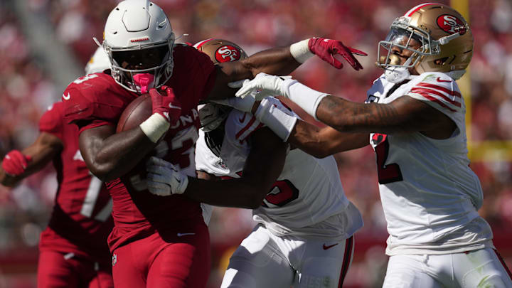 Sep 21, 2025; Santa Clara, California, USA; Arizona Cardinals running back Trey Benson (33) carries the ball as San Francisco 49ers safety Jason Pinnock (25) defends during the second half at Levi's Stadium. Mandatory Credit: Cary Edmondson-Imagn Images