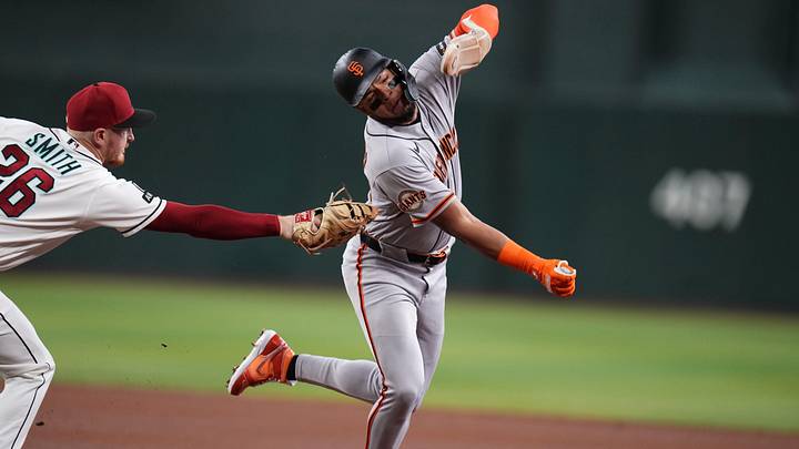 San Francisco Giants base runner Victor Bericoto (78) is tagged out by Arizona Diamondback infielder Pavin Smith (26) at Chase Field in Phoenix.
