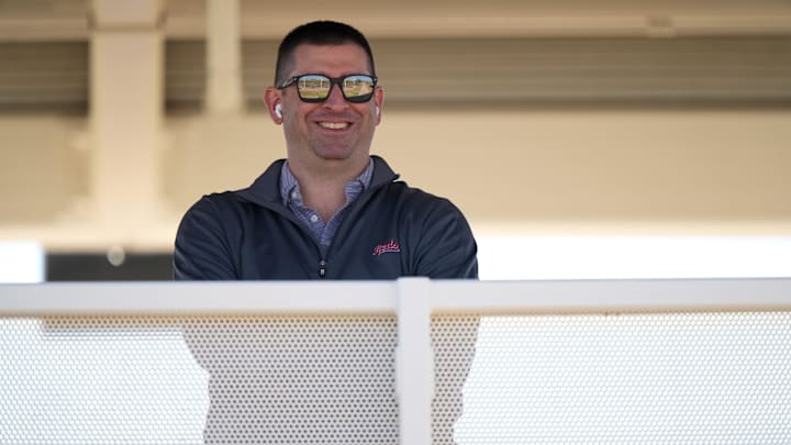 Cincinnati Reds President of Baseball Operations Nick Krall smiles as he takes a phone call during spring training workouts, Friday, Feb. 16, 2024, at the team's spring training facility in Goodyear, Ariz.