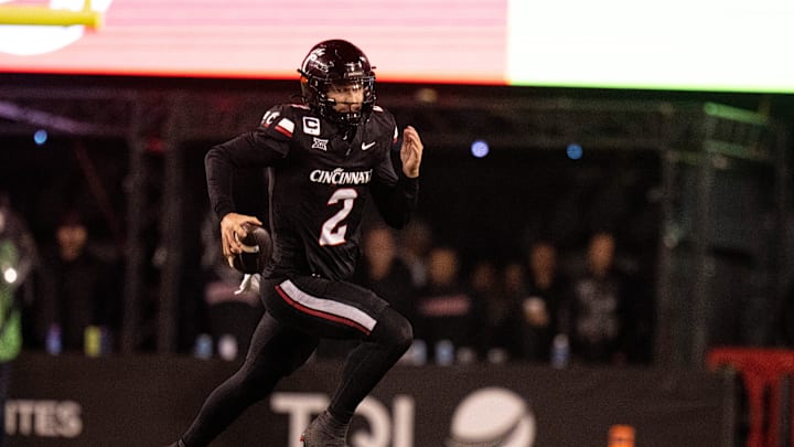 Cincinnati Bearcats quarterback Brendan Sorsby (2) runs for a first down in the fourth quarter of the NCAA football game between the Cincinnati Bearcats and BYU Cougars at Nippert Stadium in Cincinnati on Nov. 22, 2025.