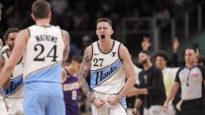 Jan 14, 2025; Atlanta, Georgia, USA; Atlanta Hawks guard Garrison Mathews (24) reacts with guard Vit Krejci (27) after making a three point shot against the Phoenix Suns during the second half at State Farm Arena. Mandatory Credit: Dale Zanine-Imagn Images