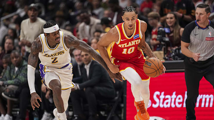 Nov 8, 2025; Atlanta, Georgia, USA; Atlanta Hawks forward Zaccharie Risacher (10) picks up a loose ball behind Los Angeles Lakers forward Jarred Vanderbilt (2) during the second half at State Farm Arena. Mandatory Credit: Dale Zanine-Imagn Images