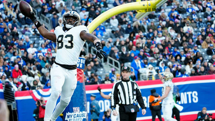 New Orleans Saints tight end Juwan Johnson (83) gets ready to spike the ball after scoring a touchdown, Sunday, December 8, 2024, in East Rutherford.