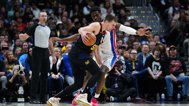 Jan 7, 2024; Denver, Colorado, USA; Denver Nuggets center Nikola Jokic (15) drives at Detroit Pistons center Jalen Duren (0) in the first quarter at Ball Arena. Mandatory Credit: Ron Chenoy-Imagn Images