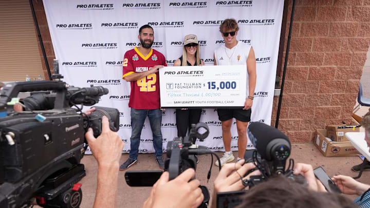 ASU quarterback Sam Leavitt poses for a photo with Pat Tillman foundation CEO Katherine Steele and Tillman scholar Seth Sifuentes after donating to the foundation during his stop at a football camp sponsored by Pro Athletes Direct at Chandler High School on May 24, 2025, in Chandler. ASU quarterback Sam Leavitt poses for a photo with Pat Tillman foundation CEO Katherine Steele and Tillman scholar Seth Sifuentes after donating to the foundation during his stop at a football camp sponsored by Pro Athletes Direct at Chandler High School on May 24, 2025, in Chandler.