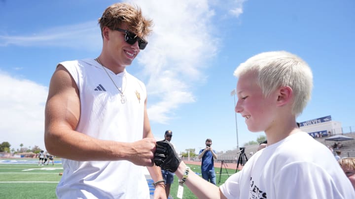 ASU quarterback Sam Leavitt fist bumps Ethan Cundiff, 10, during a football camp sponsored by Pro Athletes Direct at Chandler High School on May 24, 2025, in Chandler.