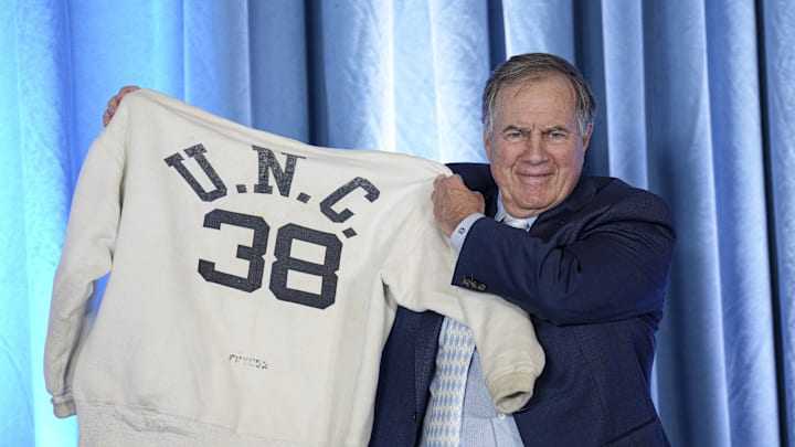 Dec 12, 2024; Chapel Hill, NC, USA; North Carolina Tar Heels new head coach Bill Belichick holds up the sweatshirt worn by his father when he was an assistant coach at New North Carolina Tar Heels new at Loudermilk Center for Excellence. Mandatory Credit: Jim Dedmon-Imagn Images Dec 12, 2024; Chapel Hill, NC, USA; North Carolina Tar Heels new head coach Bill Belichick holds up the sweatshirt worn by his father when he was an assistant coach at New North Carolina Tar Heels new at Loudermilk Center for Excellence. Mandatory Credit: Jim Dedmon-Imagn Images