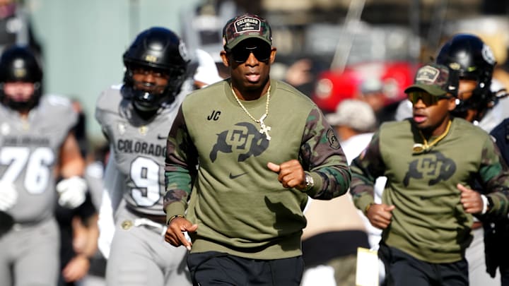 Nov 11, 2023; Boulder, Colorado, USA; Colorado Buffaloes head coach Deion Sanders runs on to the field before the first half against the Arizona Wildcats at Folsom Field. Mandatory Credit: Ron Chenoy-Imagn Images
