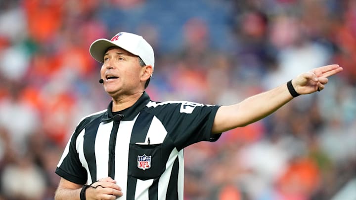 Aug 26, 2023; Denver, Colorado, USA; NFL referee Brad Allen (122) calls a personal foul penalty against the Los Angeles Rams during the first quarter at Empower Field at Mile High.