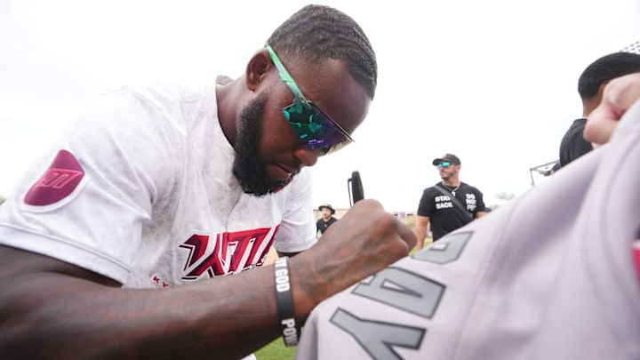 Arizona Cardinals safety Budda Baker signs autographs for fans before Kyler Murray's celebrity softball game at Salt River Fields in Scottsdale, on May 17, 2025.