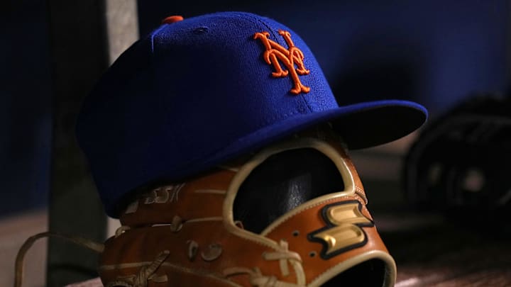 Aug 2, 2021; Miami, Florida, USA;  detailed view of the cap and glove of New York Mets shortstop Javier Baez (not pictured) in the dugout prior to the game against the Miami Marlins at loanDepot park. Mandatory Credit: Jasen Vinlove-Imagn Images