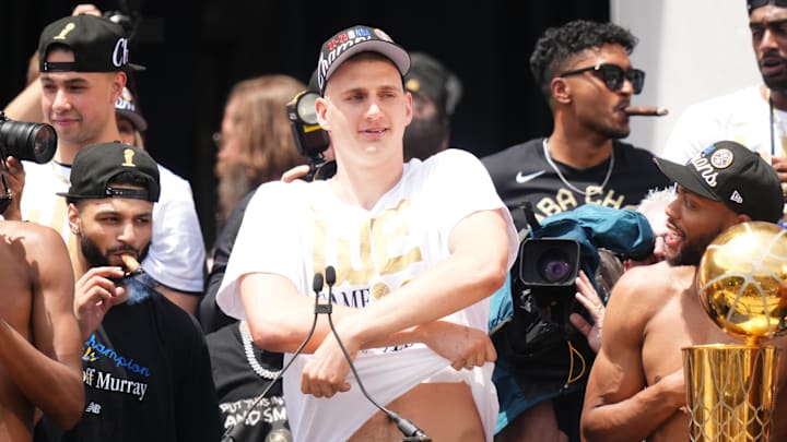 Jun 15, 2023; Denver, CO, USA; 
Denver Nuggets center Nikola Jokic (15) pretends to take his jersey off during the championship parade after the Denver Nuggets won the 2023 NBA Finals. Mandatory Credit: Ron Chenoy-Imagn Images
