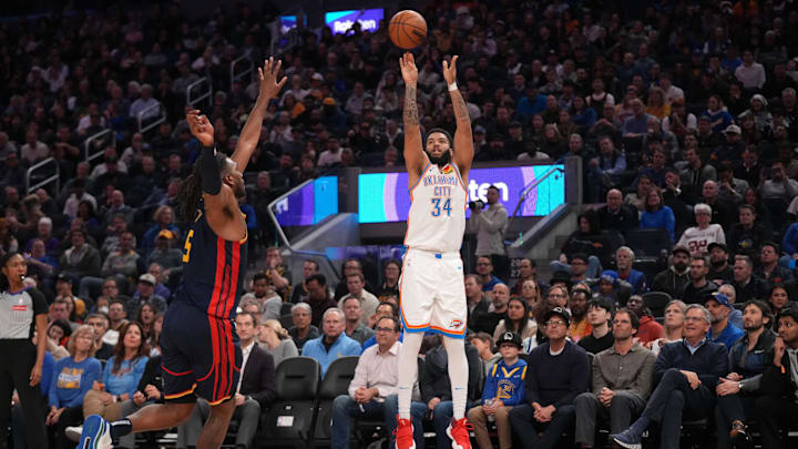 Jan 29, 2025; San Francisco, California, USA; Oklahoma City Thunder guard Kenrich Williams (34) shoots over Golden State Warriors forward Kevon Looney (5) in the second quarter at the Chase Center. Mandatory Credit: Cary Edmondson-Imagn Images