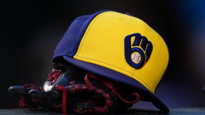 Jul 3, 2024; Denver, Colorado, USA; Detailed view of a Milwaukee Brewers cap and glove during the game against the Colorado Rockies at Coors Field. Mandatory Credit: Ron Chenoy-Imagn Images