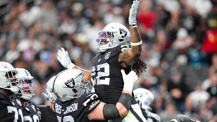 Dec 22, 2024; Paradise, Nevada, USA; Las Vegas Raiders running back Alexander Mattison (22) celebrates with Las Vegas Raiders guard Jackson Powers-Johnson (58) after scoring a touchdown against the Jacksonville Jaguars during the second quarter at Allegiant Stadium. Mandatory Credit: Stephen R. Sylvanie-Imagn Images