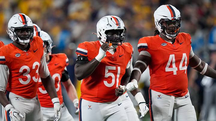 Sep 19, 2026; Charlotte, North Carolina, USA; Reaction by Virginia Cavaliers defensive end Nnanna Anyanwu (33), defensive tackle Sichan John (51) and defensive tackle Darrion Henry-Young (44) during the second half against the West Virginia Mountaineers at Bank of America Stadium. Mandatory Credit: Jim Dedmon-Imagn Images Sep 19, 2026; Charlotte, North Carolina, USA; Reaction by Virginia Cavaliers defensive end Nnanna Anyanwu (33), defensive tackle Sichan John (51) and defensive tackle Darrion Henry-Young (44) during the second half against the West Virginia Mountaineers at Bank of America Stadium. Mandatory Credit: Jim Dedmon-Imagn Images