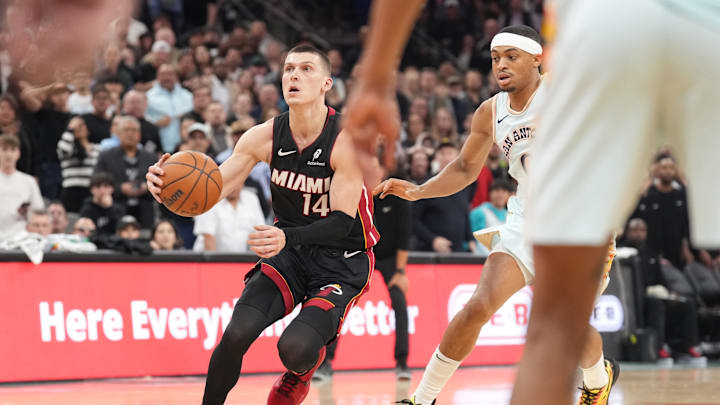 Feb 1, 2025; San Antonio, Texas, USA; Miami Heat drives to the basket past San Antonio Spurs guard Tyler Herro (14) during the second half at Frost Bank Center. Mandatory Credit: Scott Wachter-Imagn Images