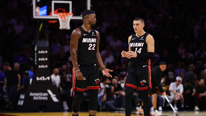 Oct 30, 2024; Miami, Florida, USA; Miami Heat forward Jimmy Butler (22) and guard Tyler Herro (14) talk on the court against the New York Knicks during the second quarter at Kaseya Center. 