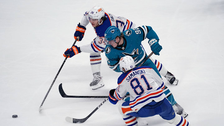 Apr 8, 2026; San Jose, California, USA;  Edmonton Oilers center Colton Dach (34) and Edmonton Oilers center Joshua Samanski (81) battle San Jose Sharks left wing Igor Chernyshov (92) for the puck in the third period at SAP Center at San Jose. Mandatory Credit: David Gonzales-Imagn Images