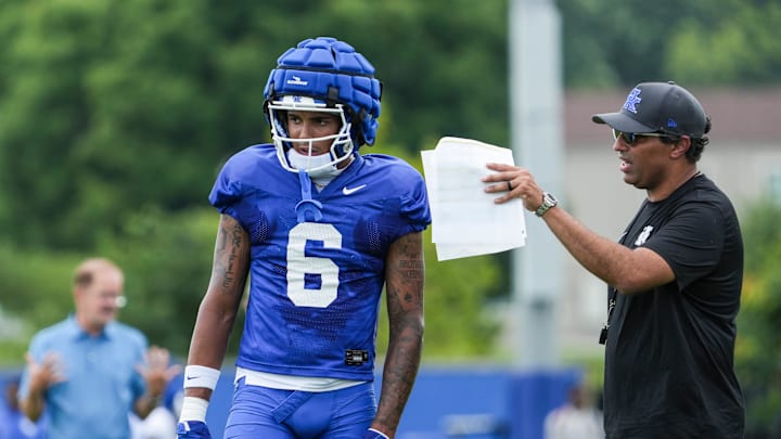 Kentucky offensive coordinator Bush Hamdan talks with wide receiver Dane Key during practice Friday. August 2, 2024 in Lexington.