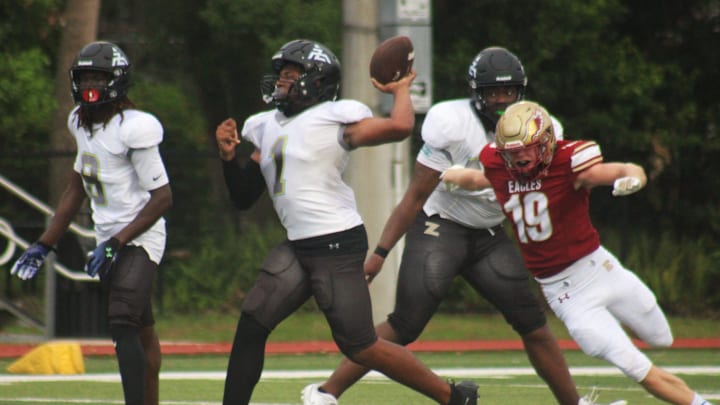 Zarephath Academy quarterback Jordan Durham (1) throws deep as Episcopal defensive end Cael Thoresen (19) rushes the passer during a high school football game on September 3, 2024. [Clayton Freeman/Florida Times-Union]