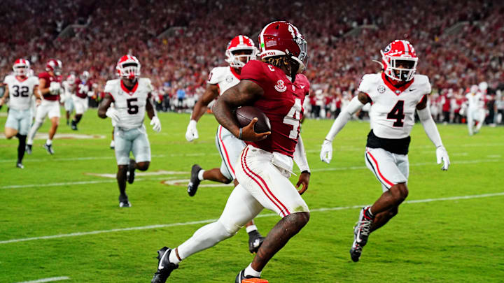 Sep 28, 2024; Tuscaloosa, Alabama, USA; Alabama Crimson Tide quarterback Jalen Milroe (4) scores a touchdown during the second quarter against the Georgia Bulldogs at Bryant-Denny Stadium. Mandatory Credit: John David Mercer-Imagn Images