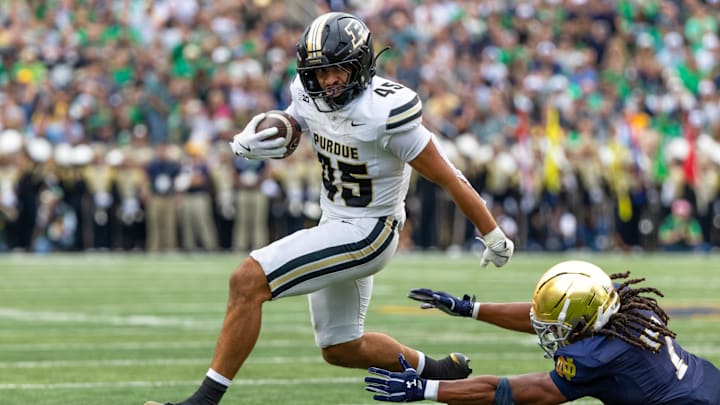 Purdue Boilermakers running back Devin Mockobee (45) jumps to avoid a tackle Purdue Boilermakers running back Devin Mockobee (45) jumps to avoid a tackle