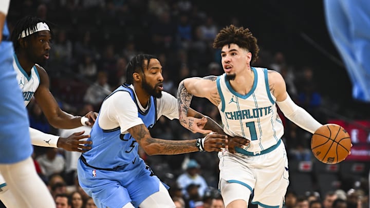 Mar 16, 2025; Inglewood, California, USA; Charlotte Hornets guard LaMelo Ball (1) moves the ball against LA Clippers forward Derrick Jones Jr. (55) during the first half at Intuit Dome. Mandatory Credit: Jonathan Hui-Imagn Images