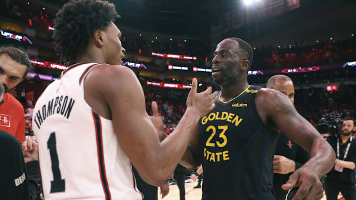 Golden State Warriors forward Draymond Green greets Houston Rockets forward Amen Thompson.