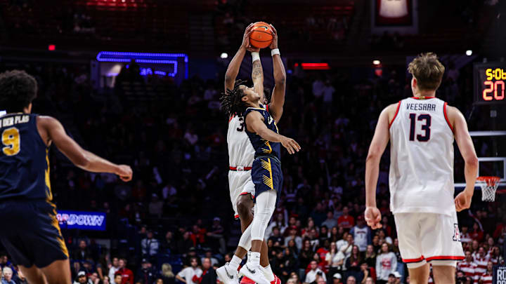 Nov 4, 2024; Tucson, Arizona, USA; Arizona Wildcats center Emmanuel Stephen (34) and Canisius Golden Griffins guard William Scott Jr. (4) jump for the ball during the second half at McKale Center. Mandatory Credit: Aryanna Frank-Imagn Images