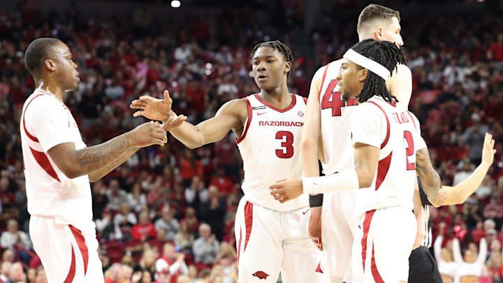 Jan 8, 2025; Fayetteville, Arkansas, USA; Arkansas Razorbacks forward Adou Thiero (3) celebrates after a play with guards Johnell Davis (1) and Boogie Fland (2) during the second half against the Ole Miss Rebels at Bud Walton Arena. Ole Miss won 73-66. Mandatory Credit: Nelson Chenault-Imagn Images
