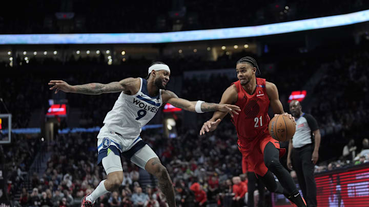 Nov 12, 2024; Portland, Oregon, USA; Portland Trail Blazers guard Rayan Rupert (21) drives to the basket against Minnesota Timberwolves shooting guard Nickel Alexander-Walker (9) during the first half at Moda Center. Mandatory Credit: Soobum Im-Imagn Images