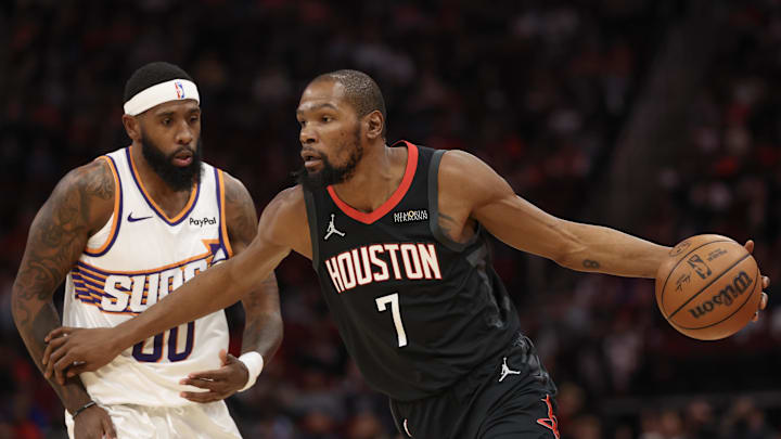 Jan 5, 2026; Houston, Texas, USA; Houston Rockets forward Kevin Durant (7) dribbles against Phoenix Suns forward Royce O'Neale (00) in the first quarter at Toyota Center. Mandatory Credit: Thomas Shea-Imagn Images