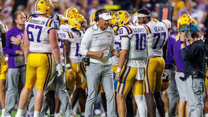 Sep 5, 2026; Baton Rouge, Louisiana, USA;  LSU Tigers head coach Lane Kiffin talks to quarterback Sam Leavitt (10) against Clemson Tigers during the first half at Tiger Stadium.  Mandatory Credit: Stephen Lew-Imagn Images
