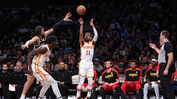 Mar 16, 2025; Brooklyn, New York, USA; Atlanta Hawks guard Trae Young (11) makes a three point basket during the first quarter against the Brooklyn Nets at Barclays Center. Mandatory Credit: Vincent Carchietta-Imagn Images Mar 16, 2025; Brooklyn, New York, USA; Atlanta Hawks guard Trae Young (11) makes a three point basket during the first quarter against the Brooklyn Nets at Barclays Center. Mandatory Credit: Vincent Carchietta-Imagn Images