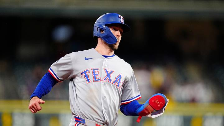 May 19, 2026; Denver, Colorado, USA; Texas Rangers center fielder Evan Carter (32) heads home to score a run in the fifth inning against the Colorado Rockies at Coors Field. Mandatory Credit: Ron Chenoy-Imagn Images