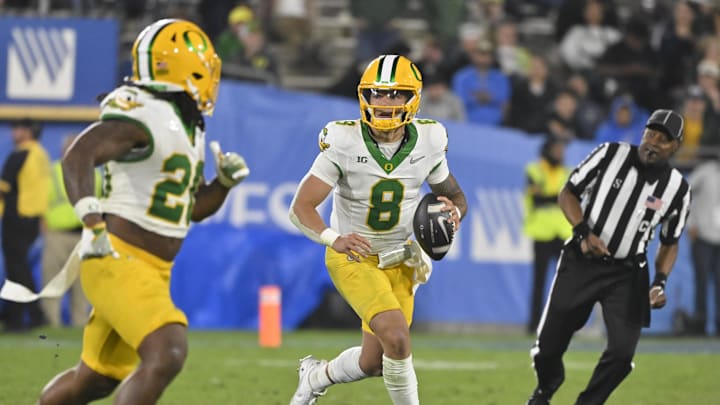 Sep 28, 2024; Pasadena, California, USA; Oregon Ducks quarterback Dillon Gabriel (8) scrambles during the third quarter against the UCLA Bruins at Rose Bowl. Mandatory Credit: Robert Hanashiro-Imagn Images Sep 28, 2024; Pasadena, California, USA; Oregon Ducks quarterback Dillon Gabriel (8) scrambles during the third quarter against the UCLA Bruins at Rose Bowl. Mandatory Credit: Robert Hanashiro-Imagn Images