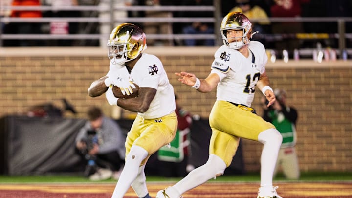 Nov 1, 2025; Chestnut Hill, Massachusetts, USA; Notre Dame Fighting Irish quarterback CJ Carr (13) hands the ball off to running back Jeremiyah Love (4).