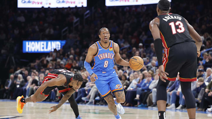 Feb 12, 2025; Oklahoma City, Oklahoma, USA; Oklahoma City Thunder forward Jalen Williams (8) drives down the court between Miami Heat guard Davion Mitchell (45) and center Bam Adebayo (13) during the second half at Paycom Center. Mandatory Credit: Alonzo Adams-Imagn Images