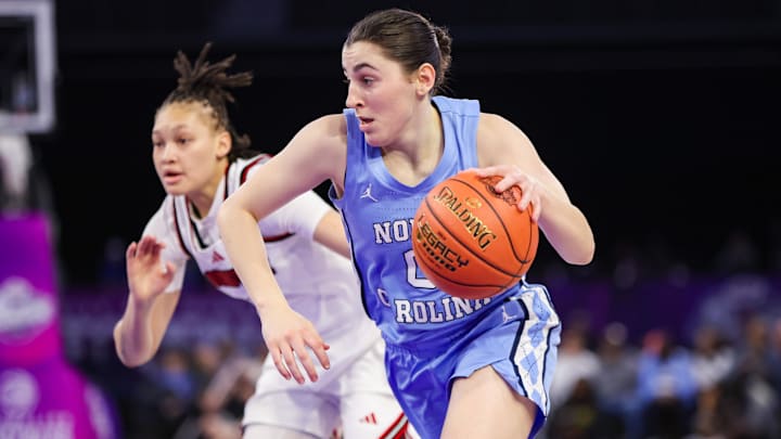 Mar 7, 2026; Duluth, GA, USA; North Carolina Tar Heels guard Lanie Grant (0) drives past Louisville Cardinals guard Imari Berry (2) in the second quarter at Gas South Arena. Mandatory Credit: Brett Davis-Imagn Images
