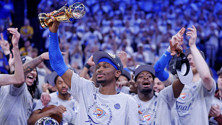 May 28, 2025; Oklahoma City, Oklahoma, USA; Oklahoma City Thunder guard Shai Gilgeous-Alexander (2) celebrates with Magic Johnson West Conference Finals MVP trophy after defeating the Minnesota Timberwolves in game five to win the western conference finals for the 2025 NBA Playoffs at Paycom Center. Mandatory Credit: Alonzo Adams-Imagn Images