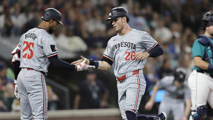 Minnesota Twins right fielder Max Kepler (26) scores and is greeted by Minnesota Twins outfielder Byron Buxton (25) during the second inning at T-Mobile Park in Seattle on June 29, 2024. Minnesota Twins right fielder Max Kepler (26) scores and is greeted by Minnesota Twins outfielder Byron Buxton (25) during the second inning at T-Mobile Park in Seattle on June 29, 2024.