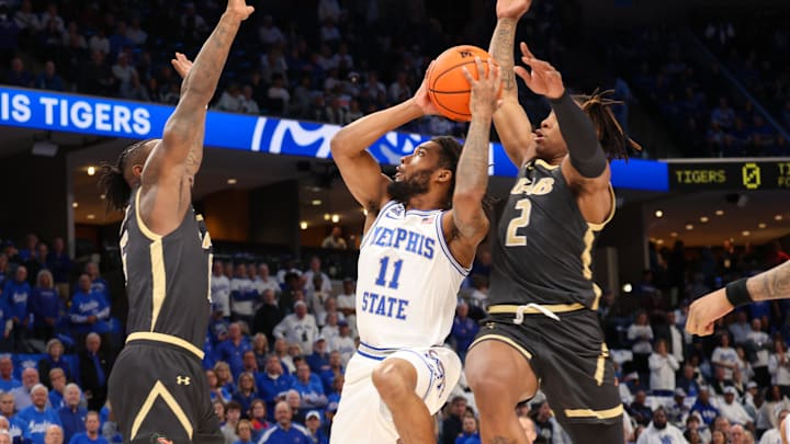 Jan 26, 2025; Memphis, Tennessee, USA; Memphis Tigers guard Tyrese Hunter (11) shoots as UAB Blazers guard Tony Toney (6) and guard Ja'Borri McGhee (2) defend during the first half at FedExForum. Mandatory Credit: Wesley Hale-Imagn Images