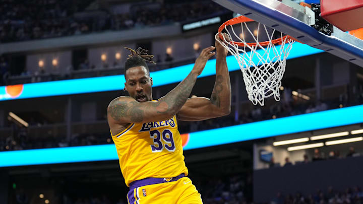 Apr 7, 2022; San Francisco, California, USA; Los Angeles Lakers center Dwight Howard (39) hangs on the rim after a dunk during the second quarter against the Golden State Warriors at Chase Center. Mandatory Credit: Darren Yamashita-Imagn Images