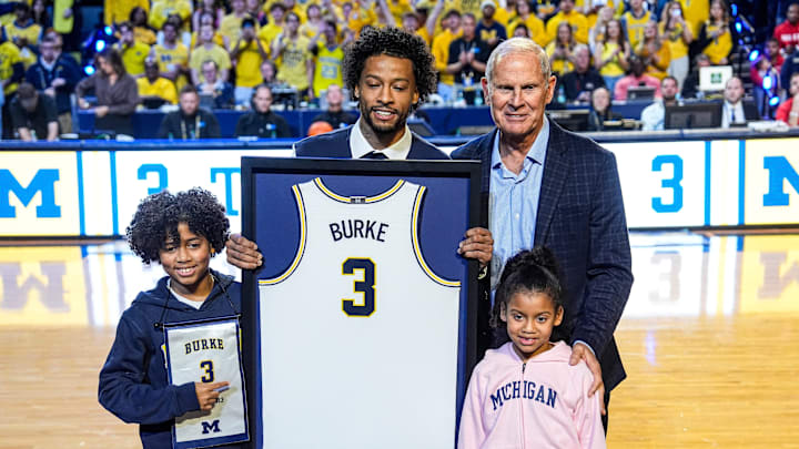 Trey Burke and former Michigan head coach John Beilein pose for a photo during his jersey retirement ceremony at Crisler Center in Ann Arbor on Friday, Jan. 23, 2026.