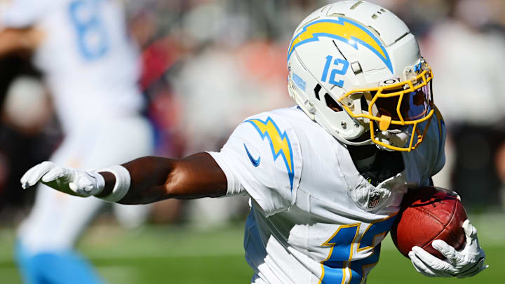Nov 3, 2024; Cleveland, Ohio, USA; Los Angeles Chargers wide receiver Derius Davis (12) runs with the ball during the first quarter against the Cleveland Browns at Huntington Bank Field. Mandatory Credit: Ken Blaze-Imagn Images