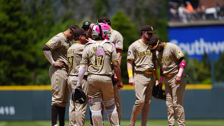 May 11, 2025; Denver, Colorado, USA; San Diego Padres pitching coach Ruben Niebla (57) (left) on the mound with players in the first inning against the Colorado Rockies at Coors Field. Mandatory Credit: Ron Chenoy-Imagn Images