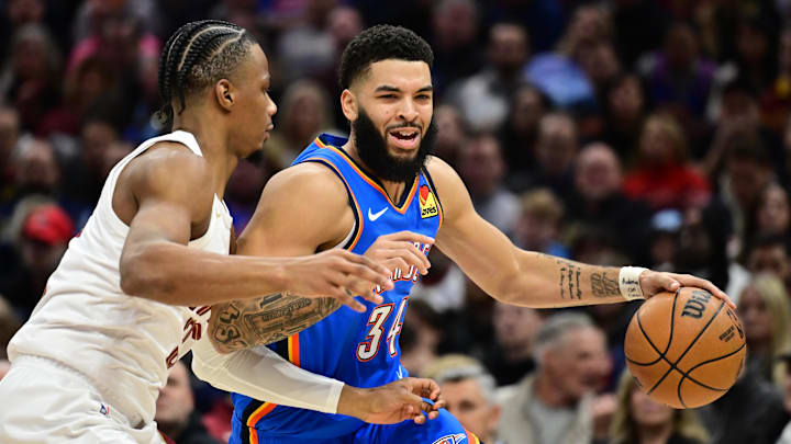 Jan 8, 2025; Cleveland, Ohio, USA; Oklahoma City Thunder forward Kenrich Williams (34) drives to the basket against Cleveland Cavaliers forward Isaac Okoro (35) during the first half at Rocket Mortgage FieldHouse. Mandatory Credit: Ken Blaze-Imagn Images
